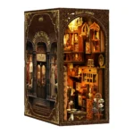 Side view of Royal Tailor DIY Book Nook Kit showcasing handcrafted tailor shop details, elegant display windows and warm LED lighting