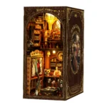 Royal Tailor DIY Book Nook Kit with warm LED lighting, showcasing a luxury tailor shop filled with elegant clothing and handcrafted miniature details