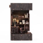 Interior view of Detective Book Nook DIY kit with bookshelf, chair, storage shelves and handcrafted miniature detective office details