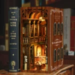 Illuminated Philosophical Classics Library book nook displayed beside a vintage book, featuring tall shelves, classical busts, a library ladder, arched windows and museum-style exhibits