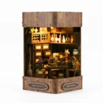 Magic Book Nook Kit with LED lights showing a glowing miniature magic bookstore front view display
