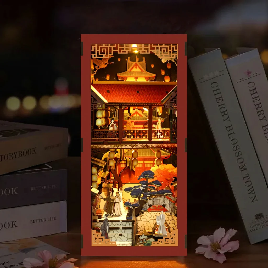 Tang Dynasty Book Nook DIY Kit displayed on bookshelf with Chinese palace miniature, warm LED lights and traditional architecture