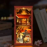 Tang Dynasty Book Nook DIY Kit displayed on bookshelf with Chinese palace miniature, warm LED lights and traditional architecture