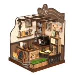 Angled view of the completed Country Cafe DIY miniature featuring a coffee bar, espresso machine, pour-over set, shelves, dining table, menu board, planter, and decorative cat.