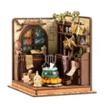 Angled view of the completed Magic Potion Workshop DIY miniature featuring a bubbling cauldron, stained-glass window, hanging magic books, potion bottles, scrolls, vines, and detailed alchemy decor.