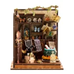 Front view of the completed Magic Potion Workshop DIY miniature featuring potion bottles, magical books, butterflies, hanging pages, a bubbling cauldron, and detailed alchemy decorations.