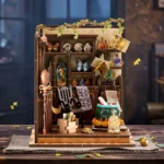 Front view of the completed Magic Potion Workshop DIY miniature featuring a bubbling cauldron, potion bottles, magical books, butterflies, vines, and detailed alchemy decorations.