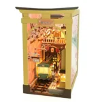 Illuminated front view of the Japan Street Cat DIY book nook featuring a miniature train, railway crossing, cherry blossoms, and Japanese street shops.
