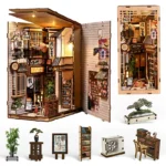 DIY Japanese Alley with Cat kit—open-style and illuminated—featuring a Japanese alleyway, miniature shops, plants, shelving, air conditioning, and small decorative accessories.